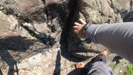 top down shot of hiker climbing rock chunks - mackenzie range, vancouver island, bc, canada