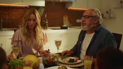 Man-and-young-woman-enjoying-dinner-on-kitchen.-Family-spending-time-together