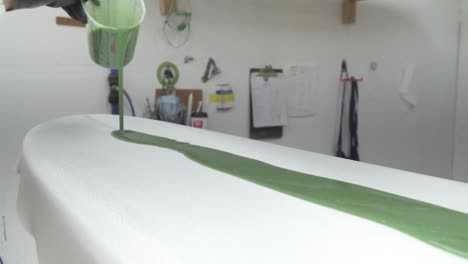 speed ramp slow motion paint pouring onto new surfboard