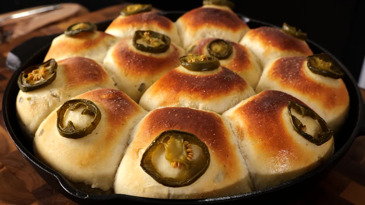 Slow motion shot showing fresh baked bread rolls straight out of the oven