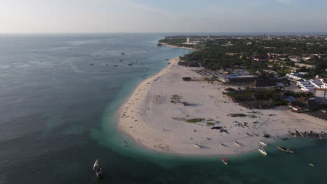 Beautiful-aerial-shot-of-shoreline-and-turquoise-ocean-in-zanzibar,-Tanzania