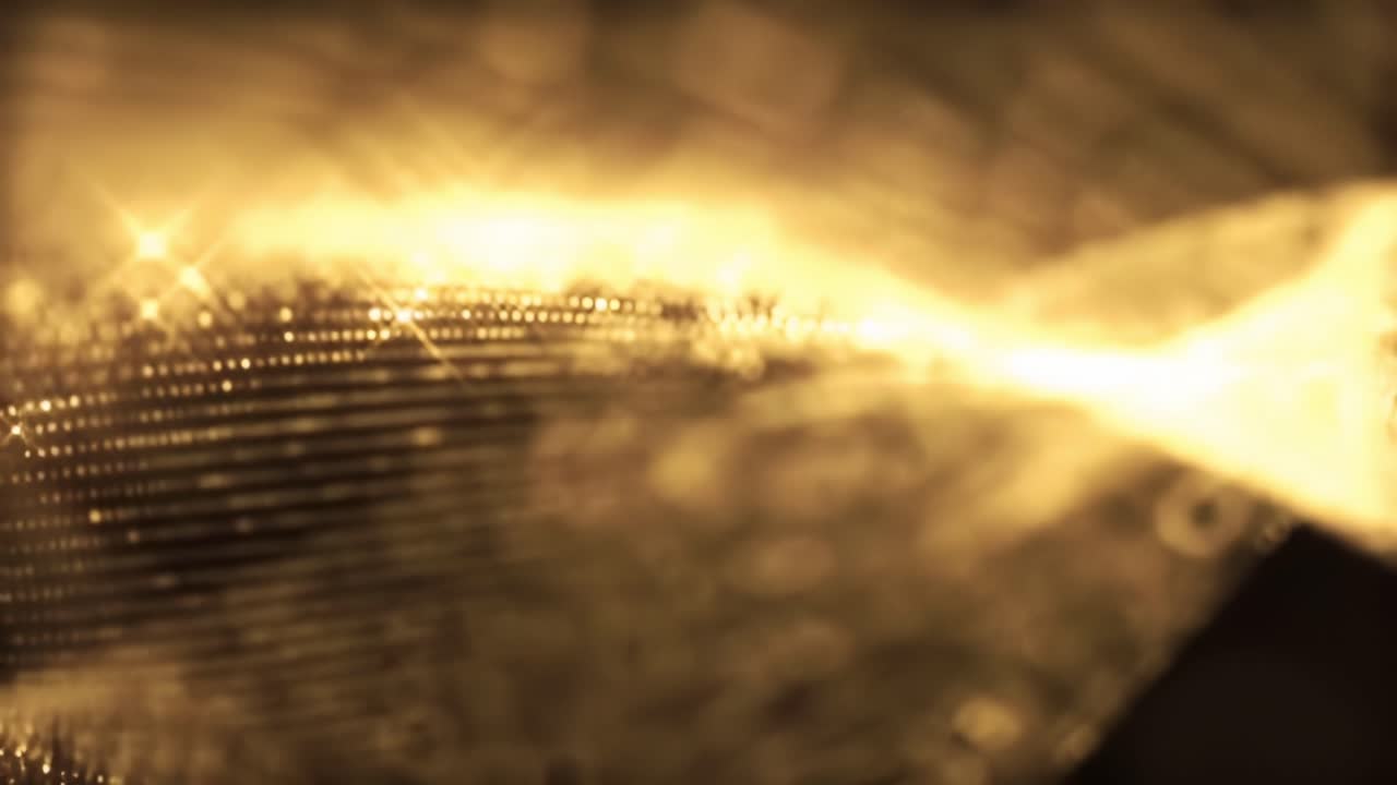 Discover the captivating details of shimmering fabric as the light dances across its surface. The close-up reveals mesmerizing textures and patterns that enhance its beauty and elegance.