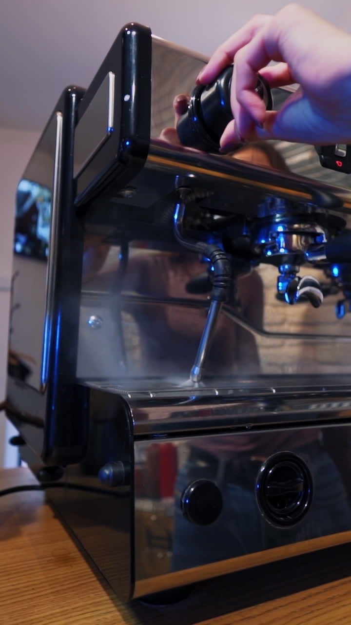 Barista at work in cafe. Barista making coffee with classic coffee machine