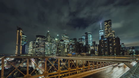 traffic over the famous brooklyn bridge at night against the backdrop of the skyscrapers of manhatta