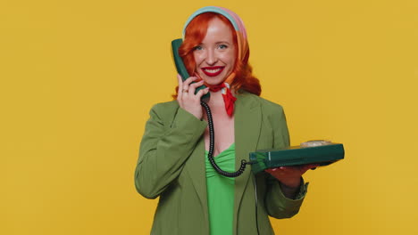 Cheerful-red-hair-girl-secretary-talking-on-wired-vintage-telephone-of-80s,-say-hey-you-call-me-back