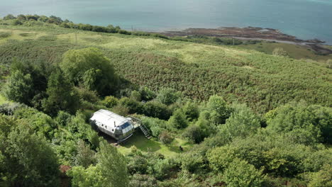 aerial reveal- a modern home opposite mull on scotlands west coast