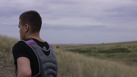 man running in the hills with weight vest