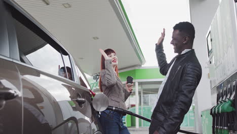 friends high-fiving at a gas station