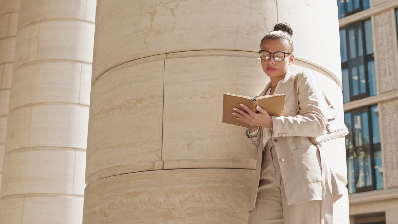 Thoughtful Business Lady Taking Notes in Planner Outdoors