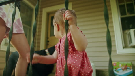 Baby-girl-playing-and-holding-on-to-rail