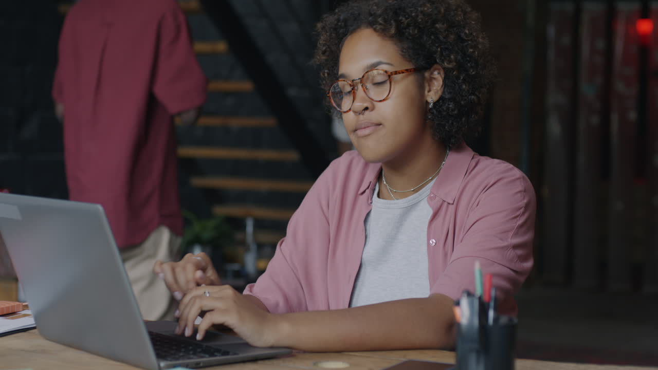 Woman Working on Laptop in a Cafe