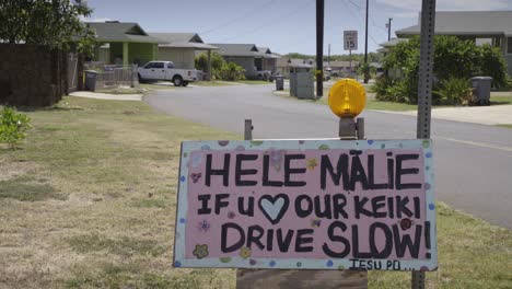 a sign in a hawaiian neighborhood urges people to slow down and respect safety