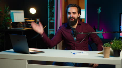 happy influencer using microphone, arriving in dimly lit home studio interior