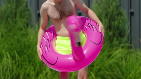 man having fun with a flamingo pool float