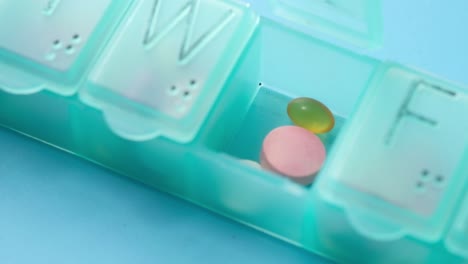 close-up view of pills in a weekly pill organizer