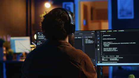 engineer wearing headphones while using coding to fortify it security