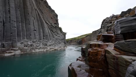 studlagil stunning valley with dramatic rock formations and a crystal clear river in iceland