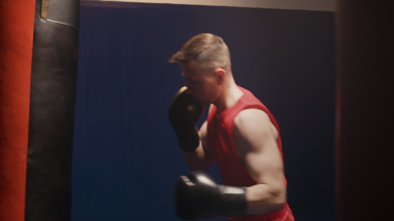Male Boxer Training with Punching Bag