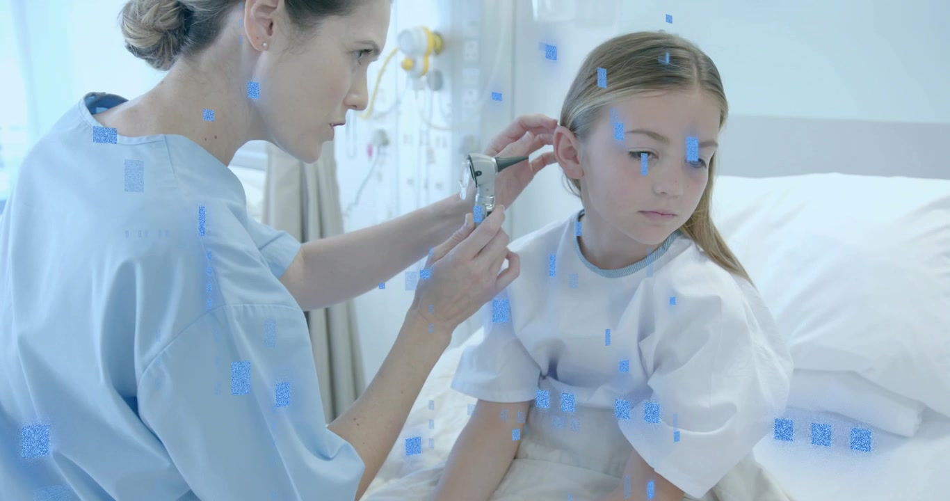 Medical professional greeting child and raising otoscope while inspecting ear in hospital room