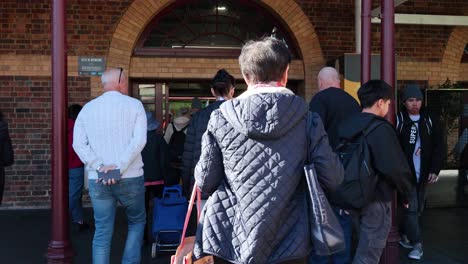 people walking into queen victoria market