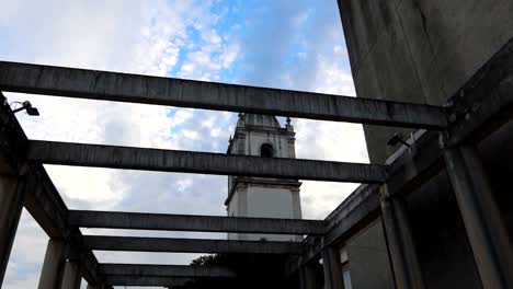 View-from-a-rooftop-supported-by-columns,-showing-the-bell-tower-of-Aveiro-Cathedral,-Portugal