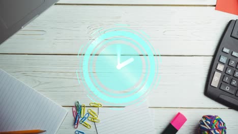 animation of clock moving over desk with notebook and calculator on desk