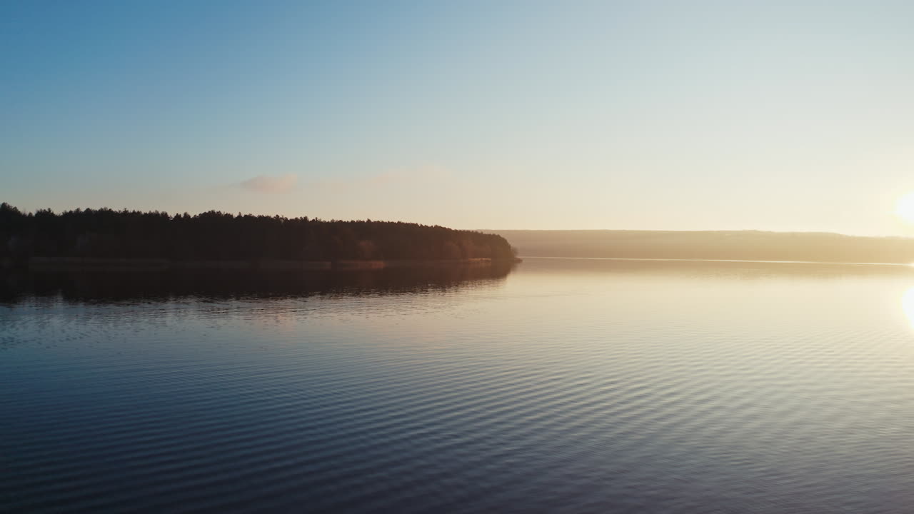 Evening river among nature.Tree without leaves over the water at sunset. Dark forest near the lake.