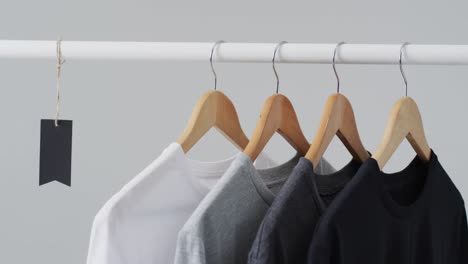 Video-of-four-t-shirts-on-hangers-and-copy-space-on-white-background