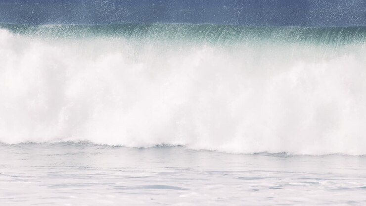 Large waves crashing forcefully in the Pacific Ocean surf