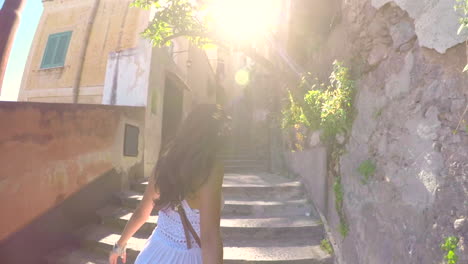 woman walking up the stairs in a charming italian town