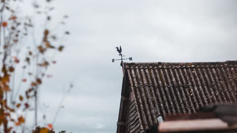 Timelapse-of-clouds-passing-behind-old-cockerel-weather-vane