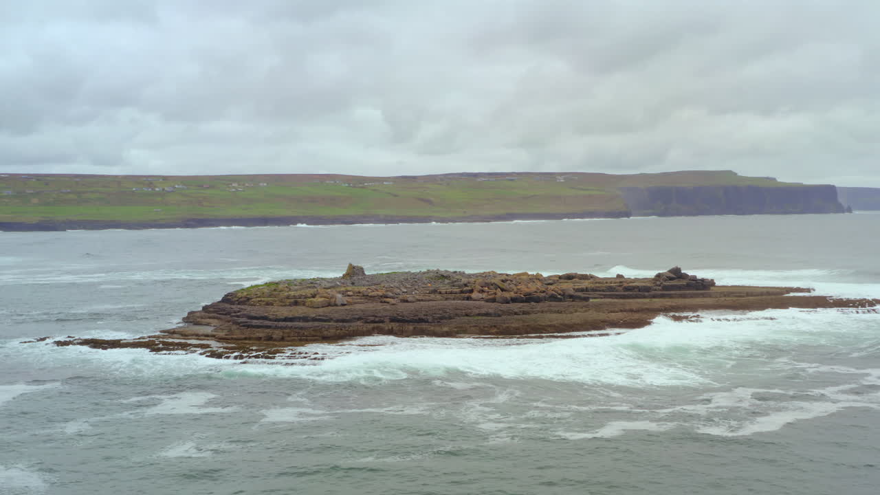 Waves crash on picturesque Crab Island as orbit aerial reveals the magnificent Cliffs of Moher
