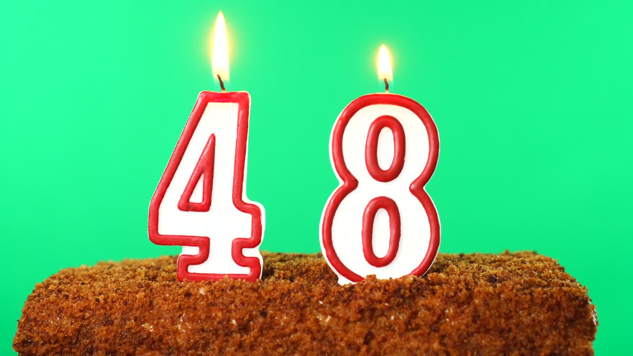 Cake with the number 48 lighted candle. Chroma key. Green Screen. Isolated