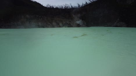 low aerial overlook of sulphur lake at white crater in ciwidey, west java, indonesia