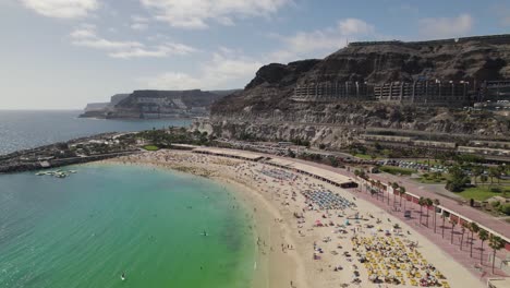 people suntanning and enjoying playa de amadores sand beach, gran canaria, canary islands, spain