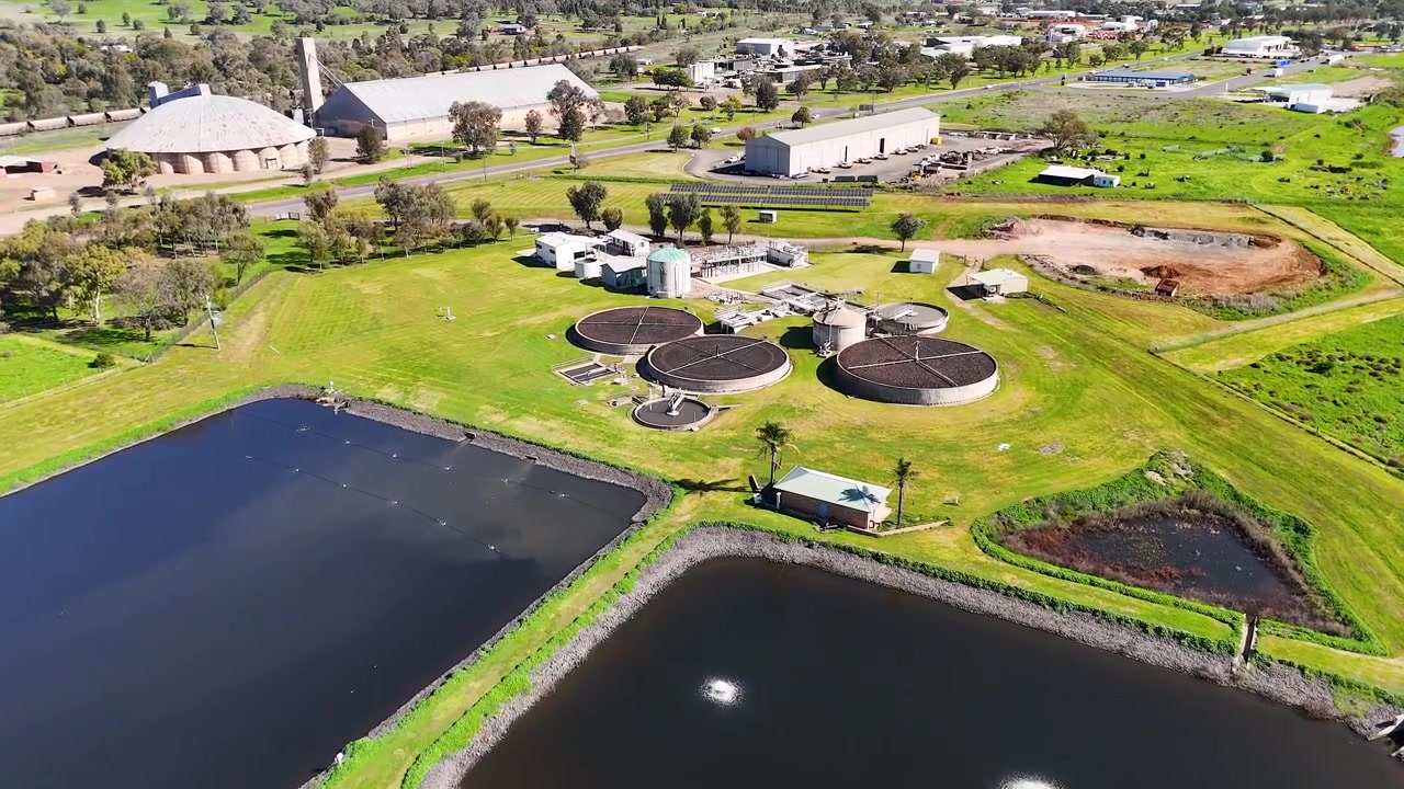 High-angle drone shot of industrial water treatment ponds and infrastructure in Gunnedah, New South Wales.