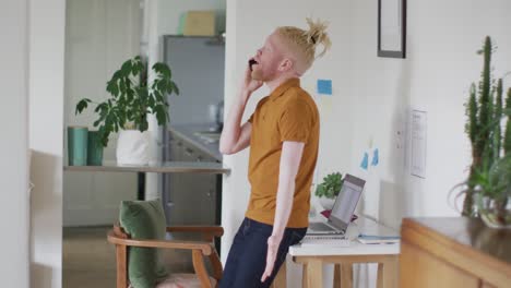 albino african american man with dreadlocks making call