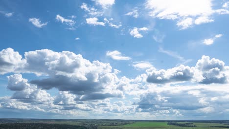 4k time lapse of moving clouds over horizon, green hilly area