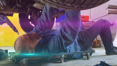 Animation-of-light-trails-over-caucasian-male-mechanic-reapiring-car