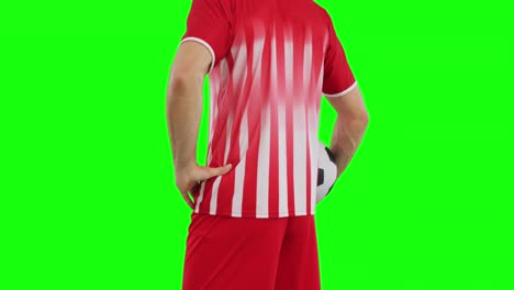 video of caucasian male soccer player with ball on green screen background