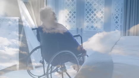 animation of sky with clouds over disabled african american woman sitting in wheelchair