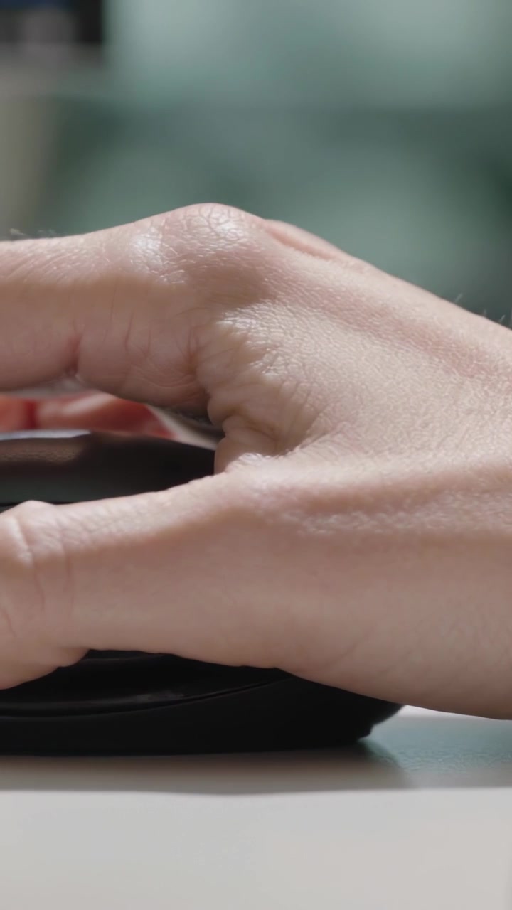 Vertical video: Clicking right hand making clicks on desk for office work with wireless mouse