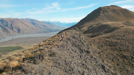 man hiking along exposed ridge of new zealand mountain lord of the rings country canterbury 60fps