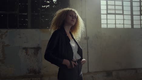 fashionable young woman in an abandoned warehouse