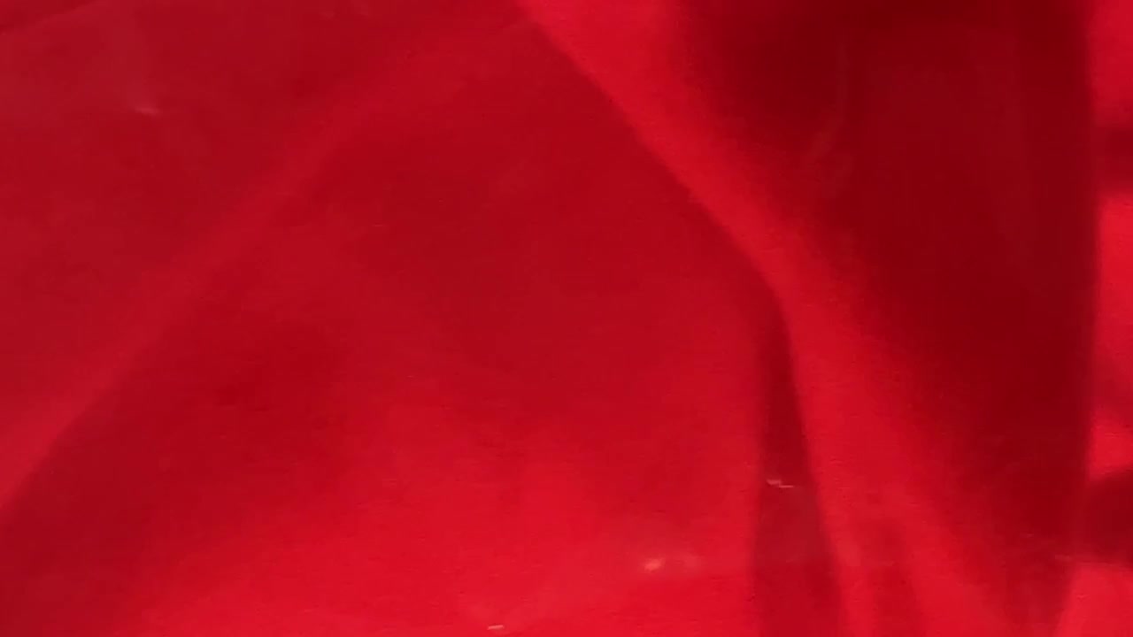 Abstract Background of Red Fabric Covered by Transparent Plastic Film