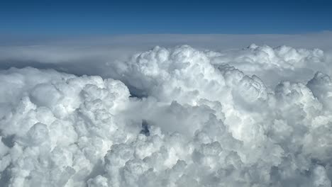 pov huge storm clouds in a blue sky seen from above