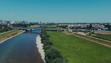 aerial - sava river bridges and riverside view of zagreb skyline under clear summer skies