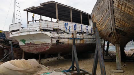 old decrepit wooden boat with holes in a boatyard in bar montenegro