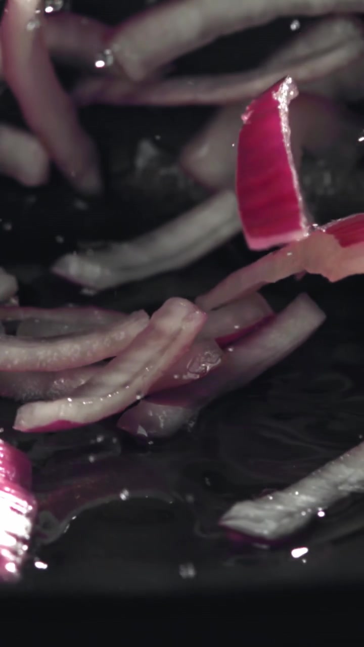 Slow Motion of Fresh Red Onion Slices Falling into Water