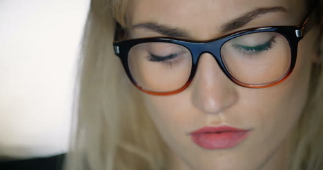 Tired-Young-Businesswoman-Using-Laptop-In-Office